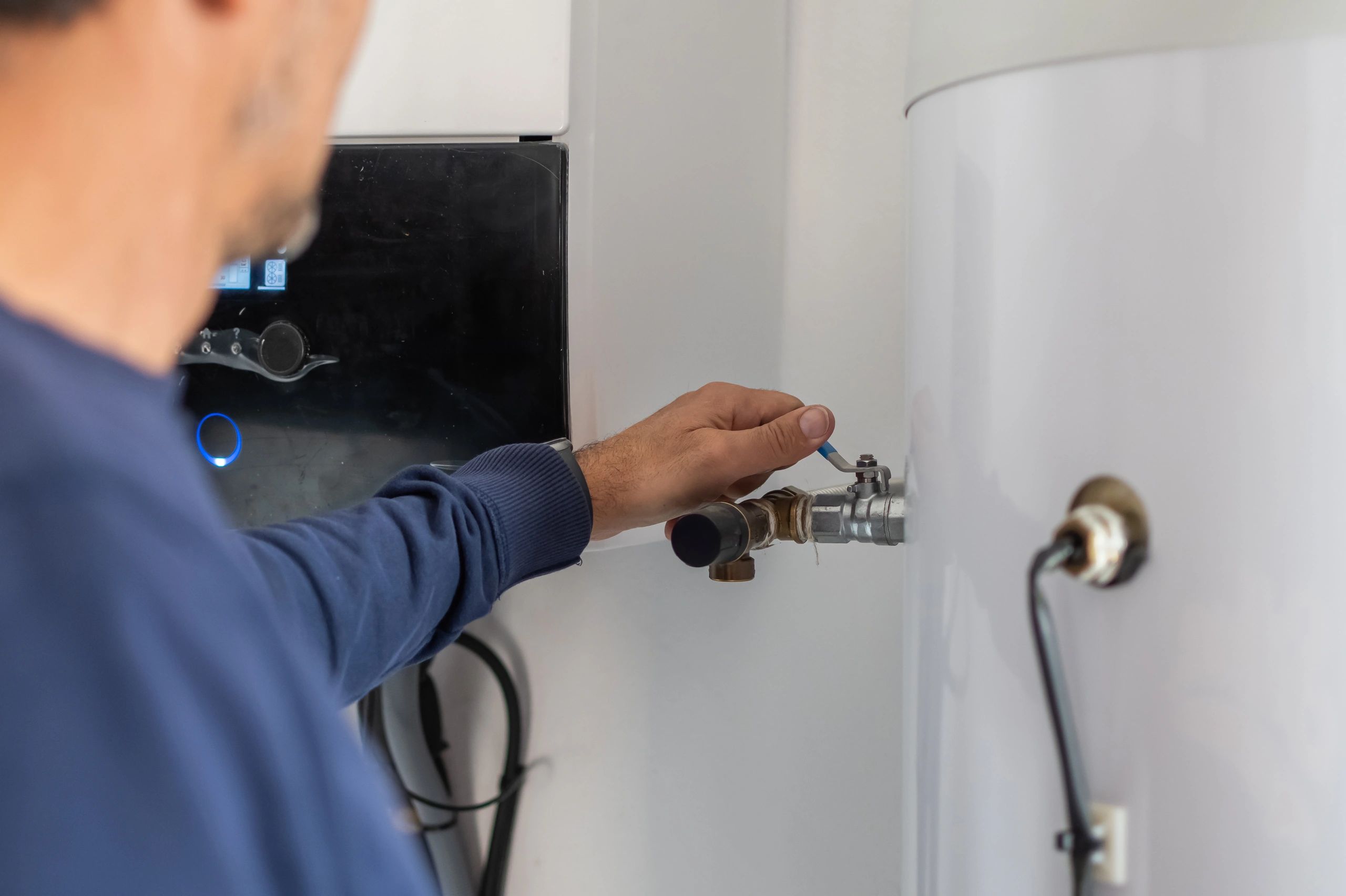 Technician servicing a residential water heater