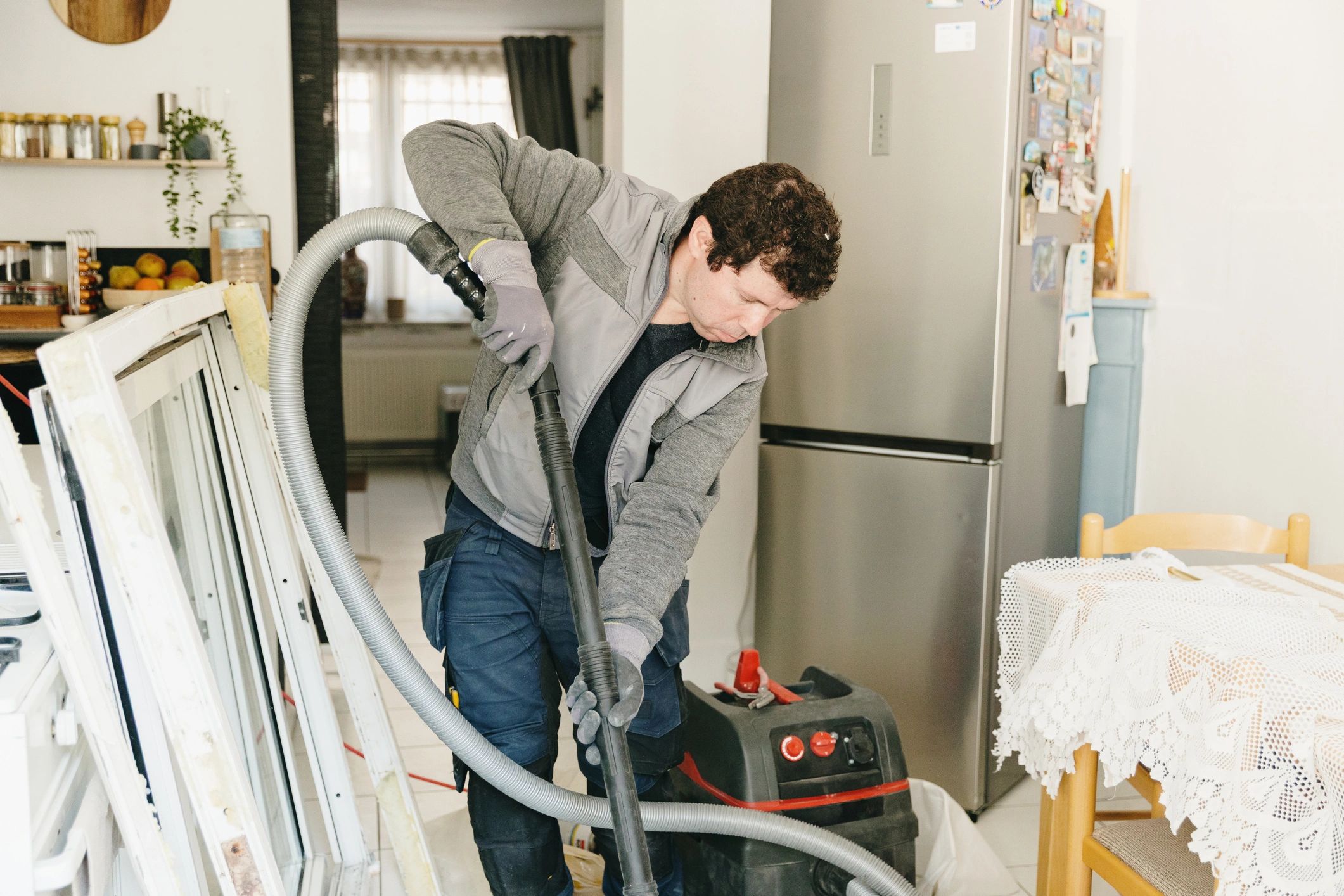 Uniformed home service worker cleaning up after the job